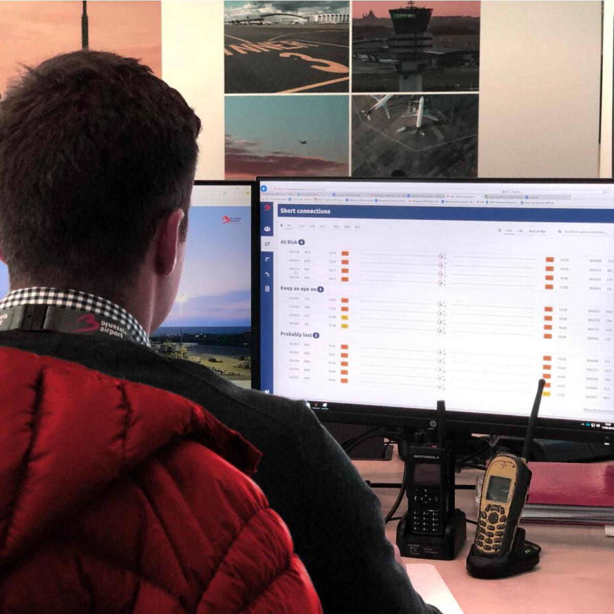 Person looking at computer screen at Brussels Airport office