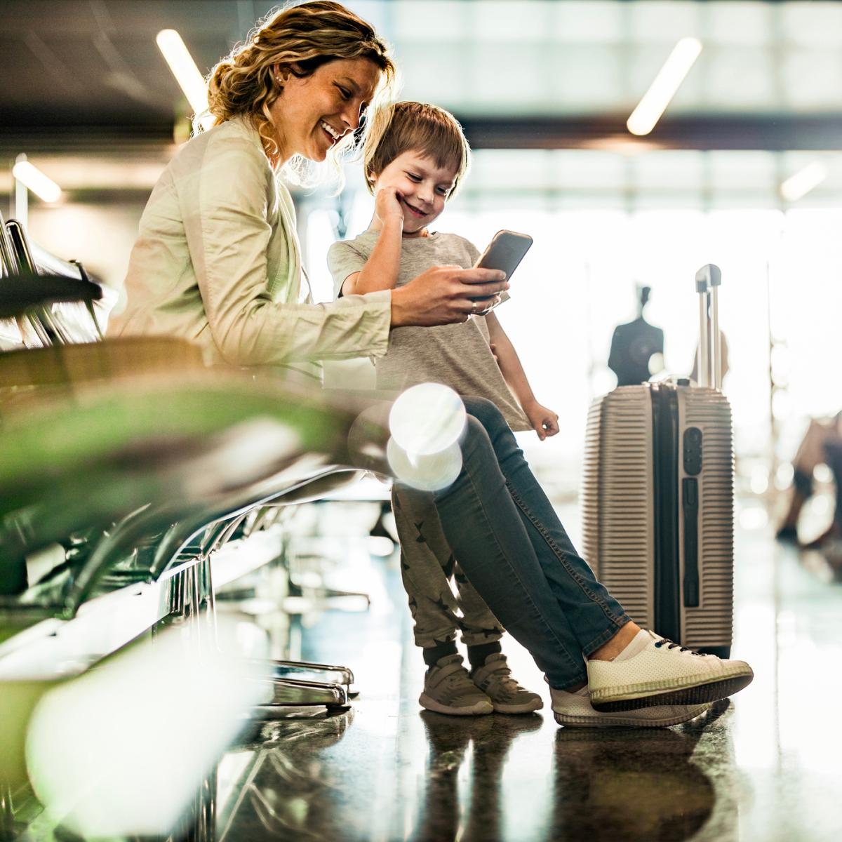 Mom and child looking at smartphone at Brussels Airport