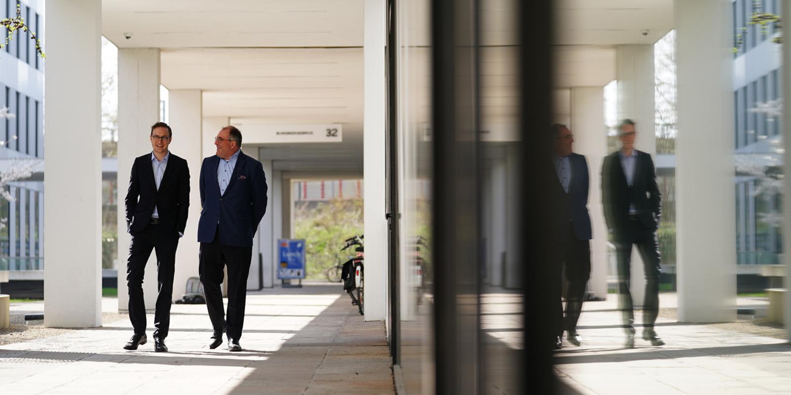 2 people in suits taking a walk