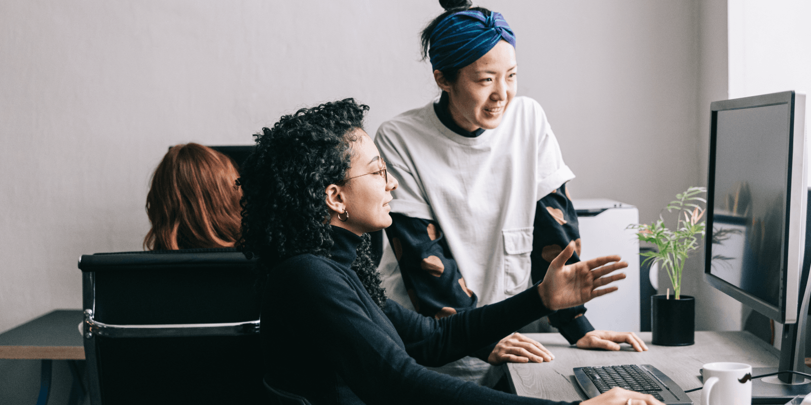 people discussing at computer screen