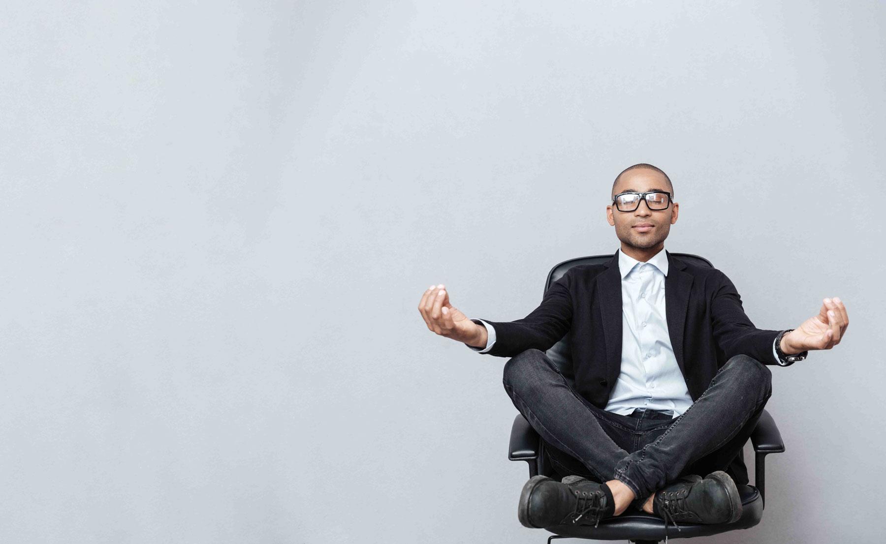 man being zen in a chair