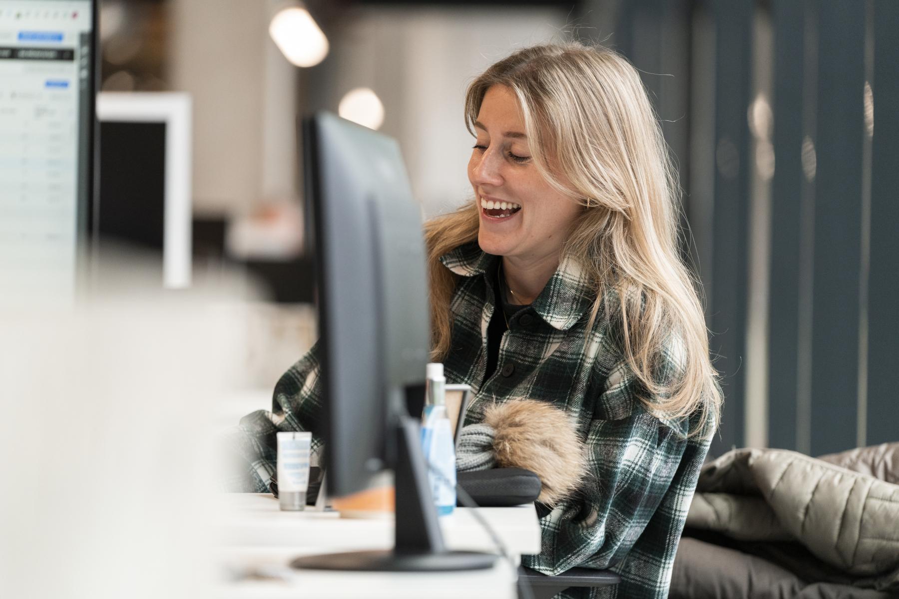 Woman laughing desk