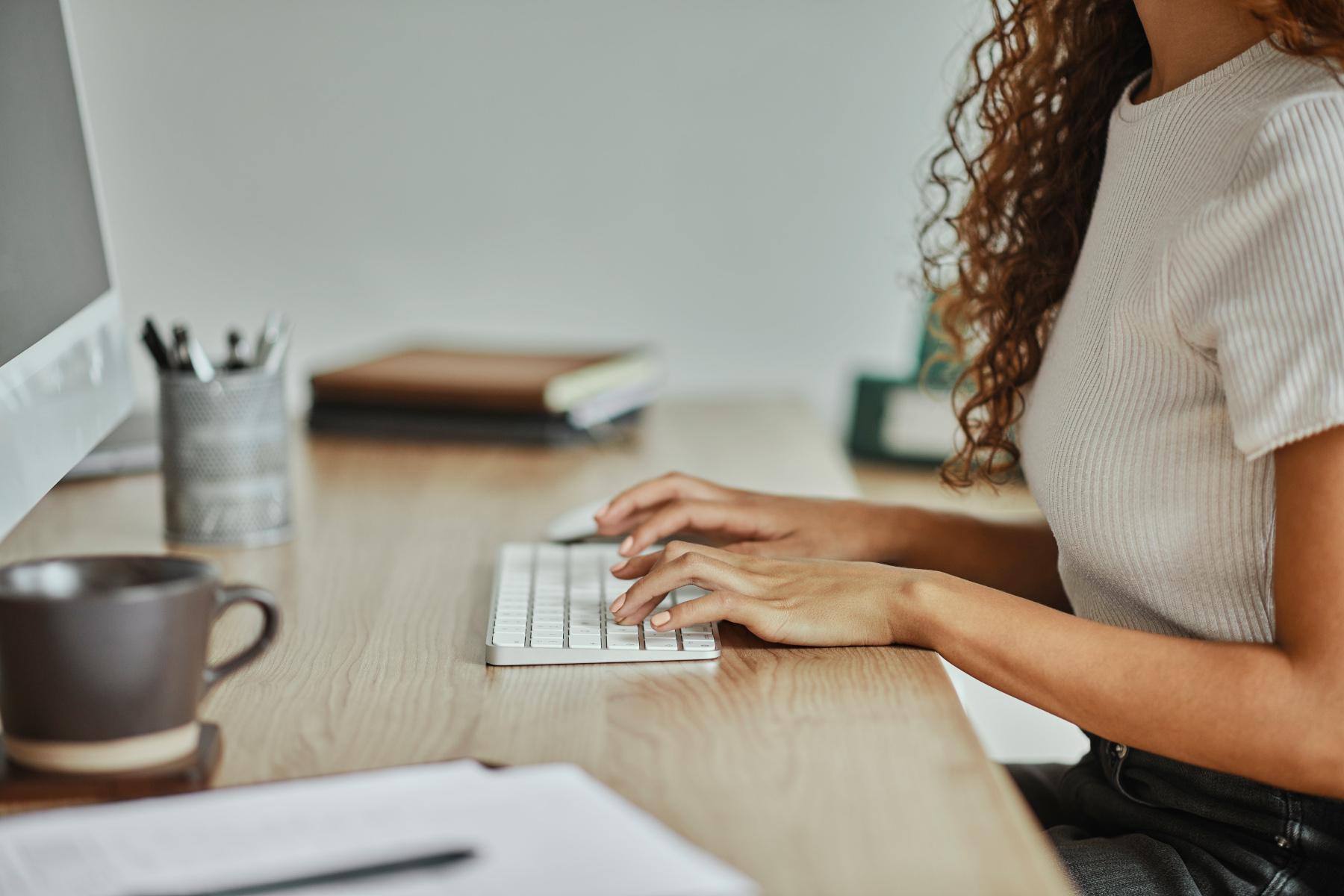 person typing wireless keyboard