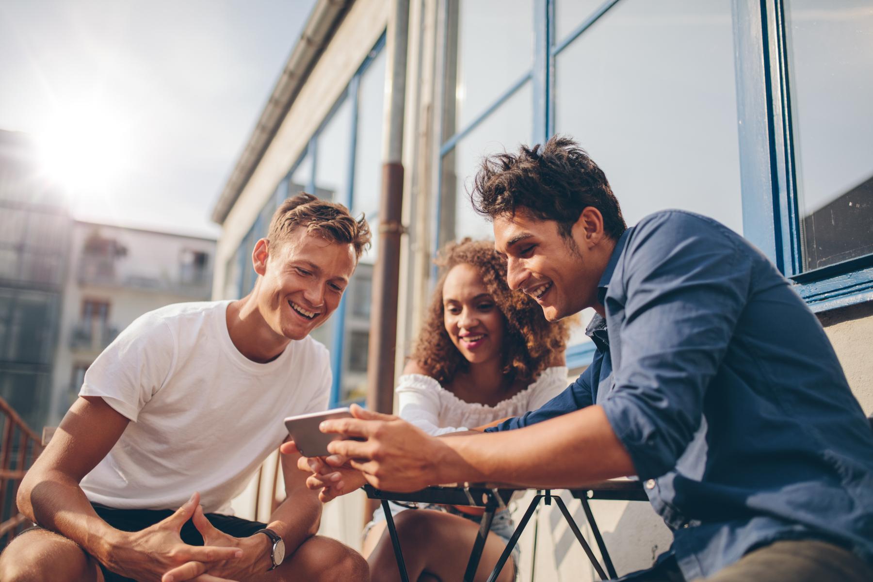 group of people watching phone