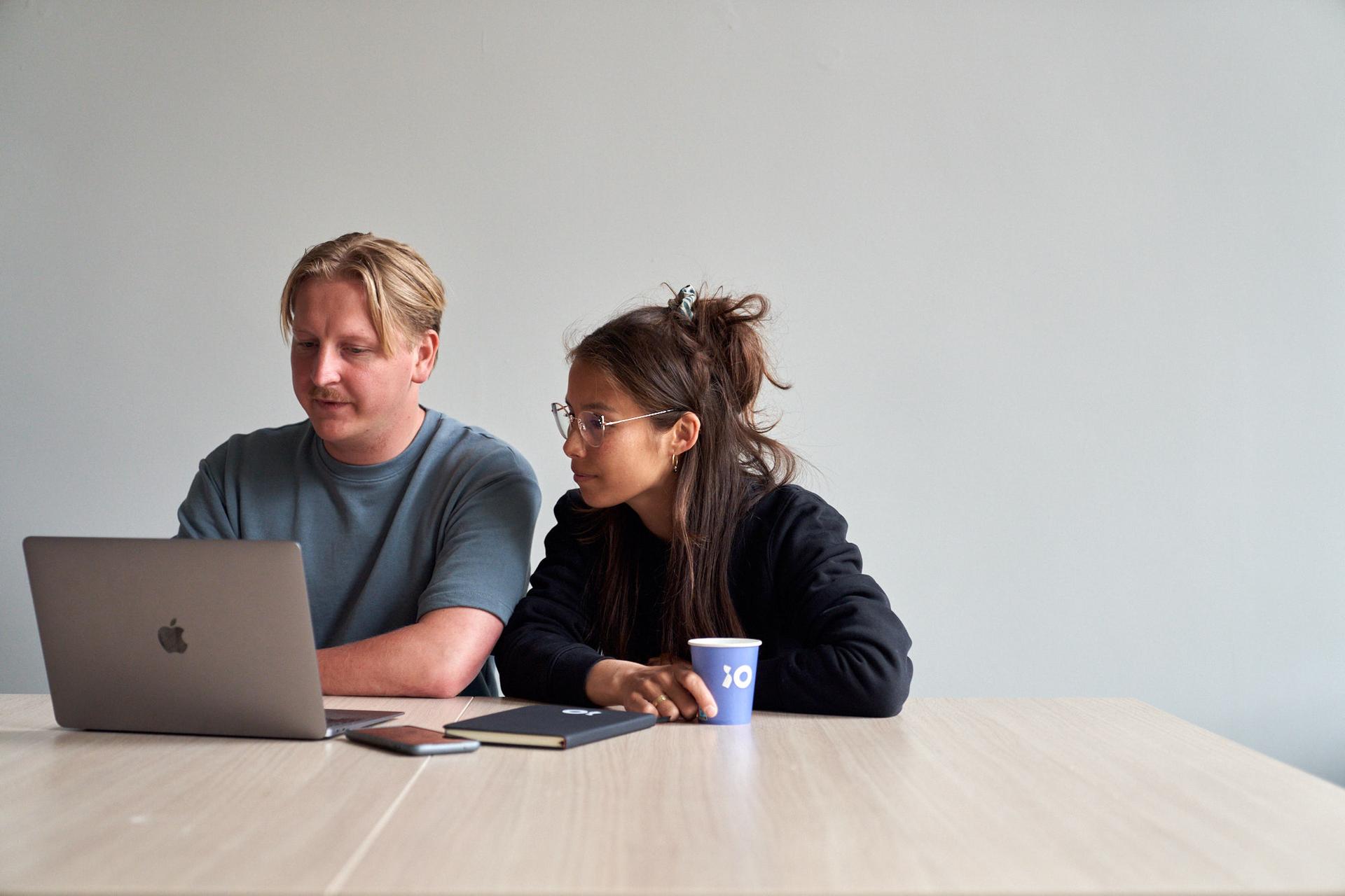 Colleagues working together on laptop