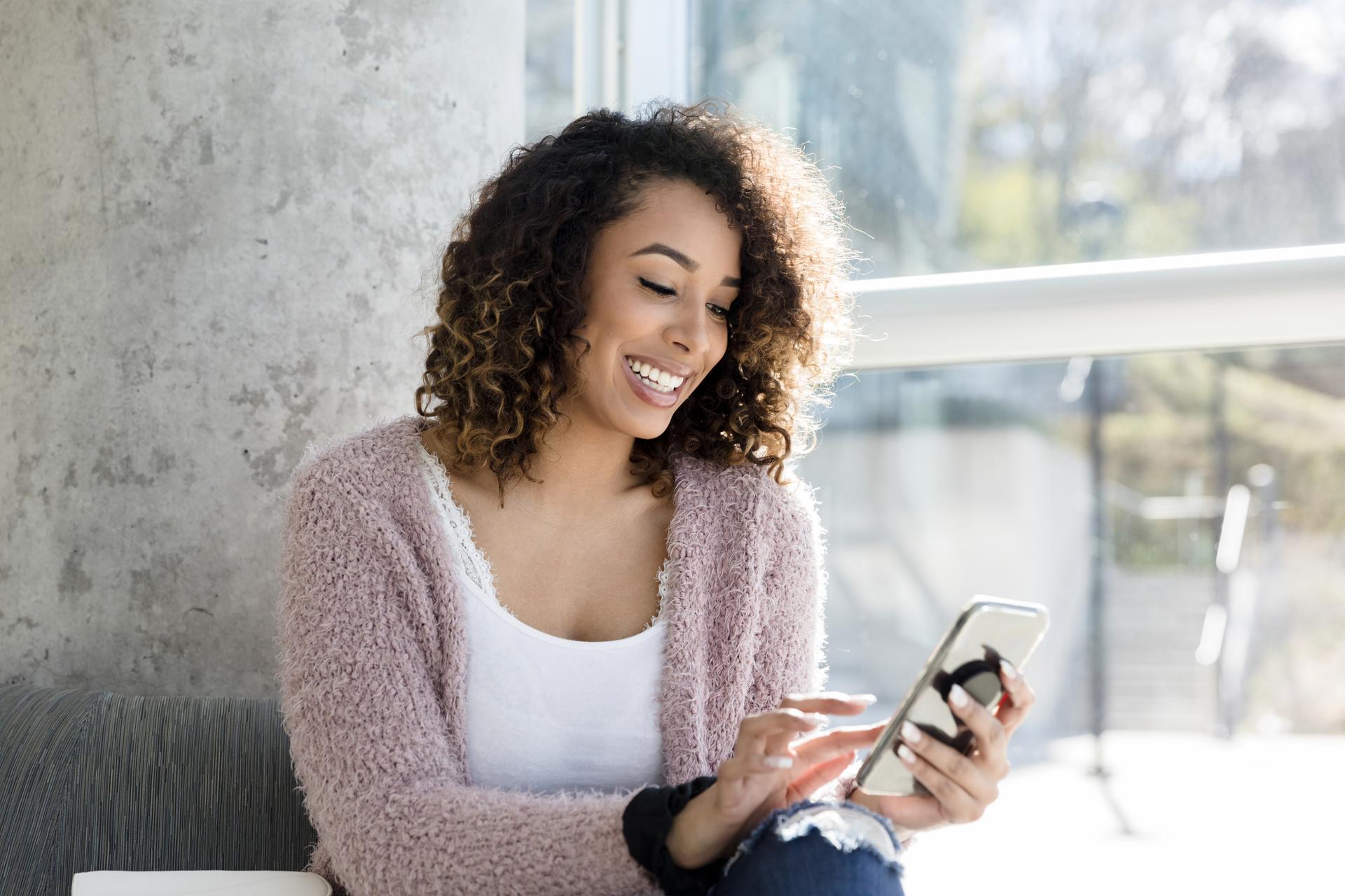 Woman smiling at phone