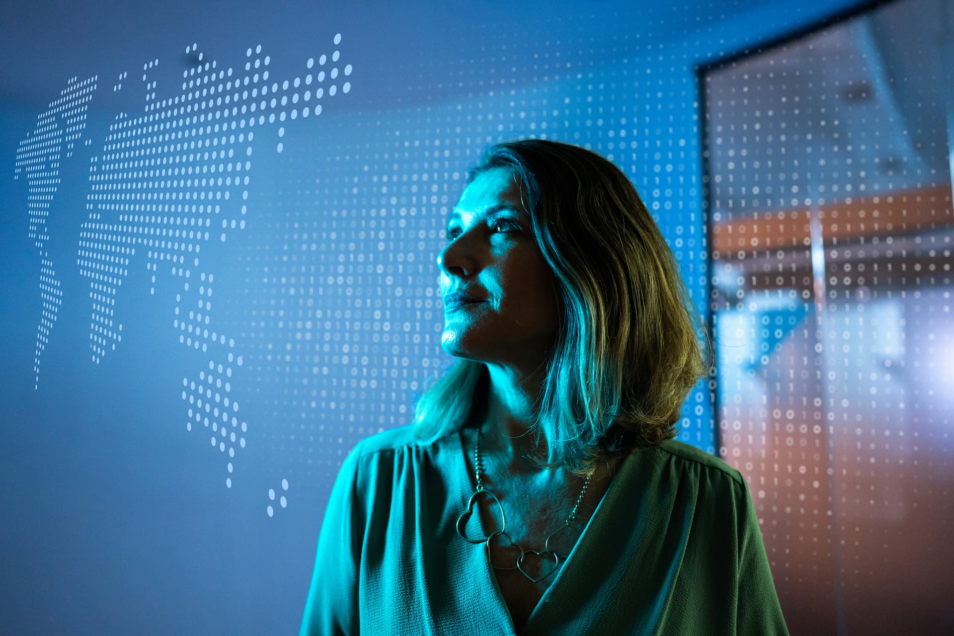 Futuristic image of woman in blue light looking up