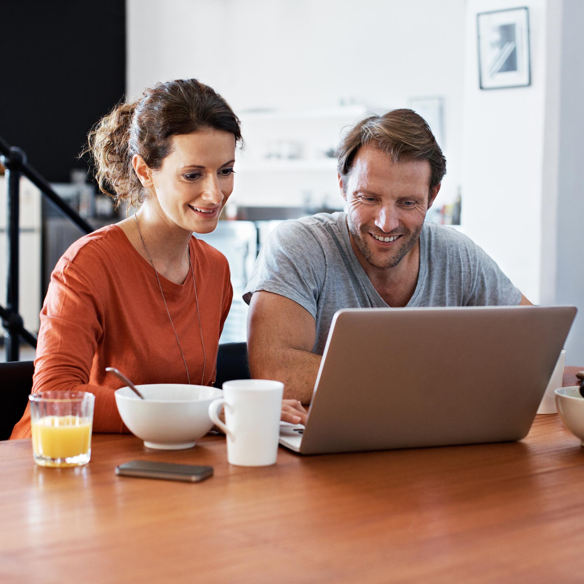 two people behind a computer