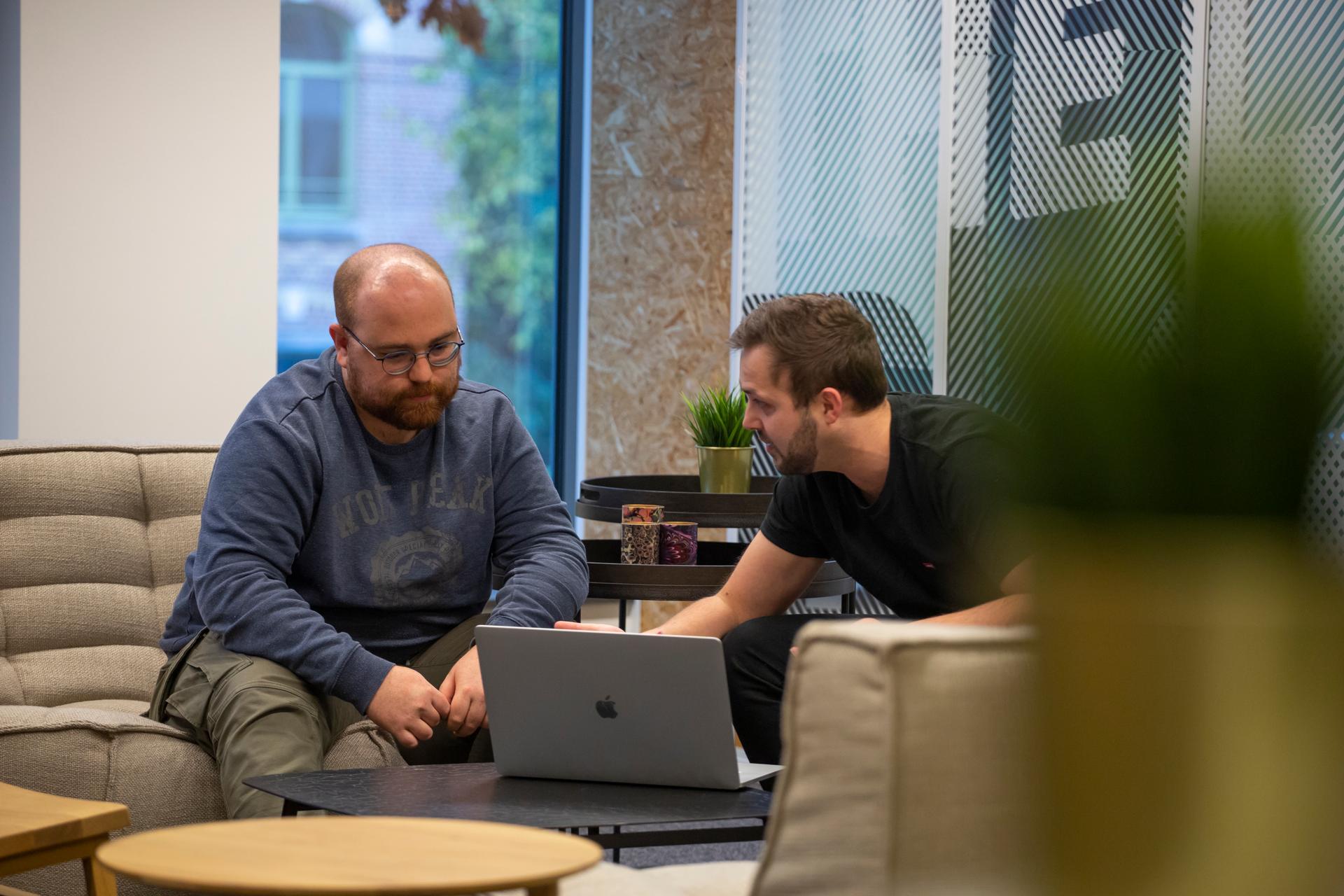 Two people working together at an iO campus