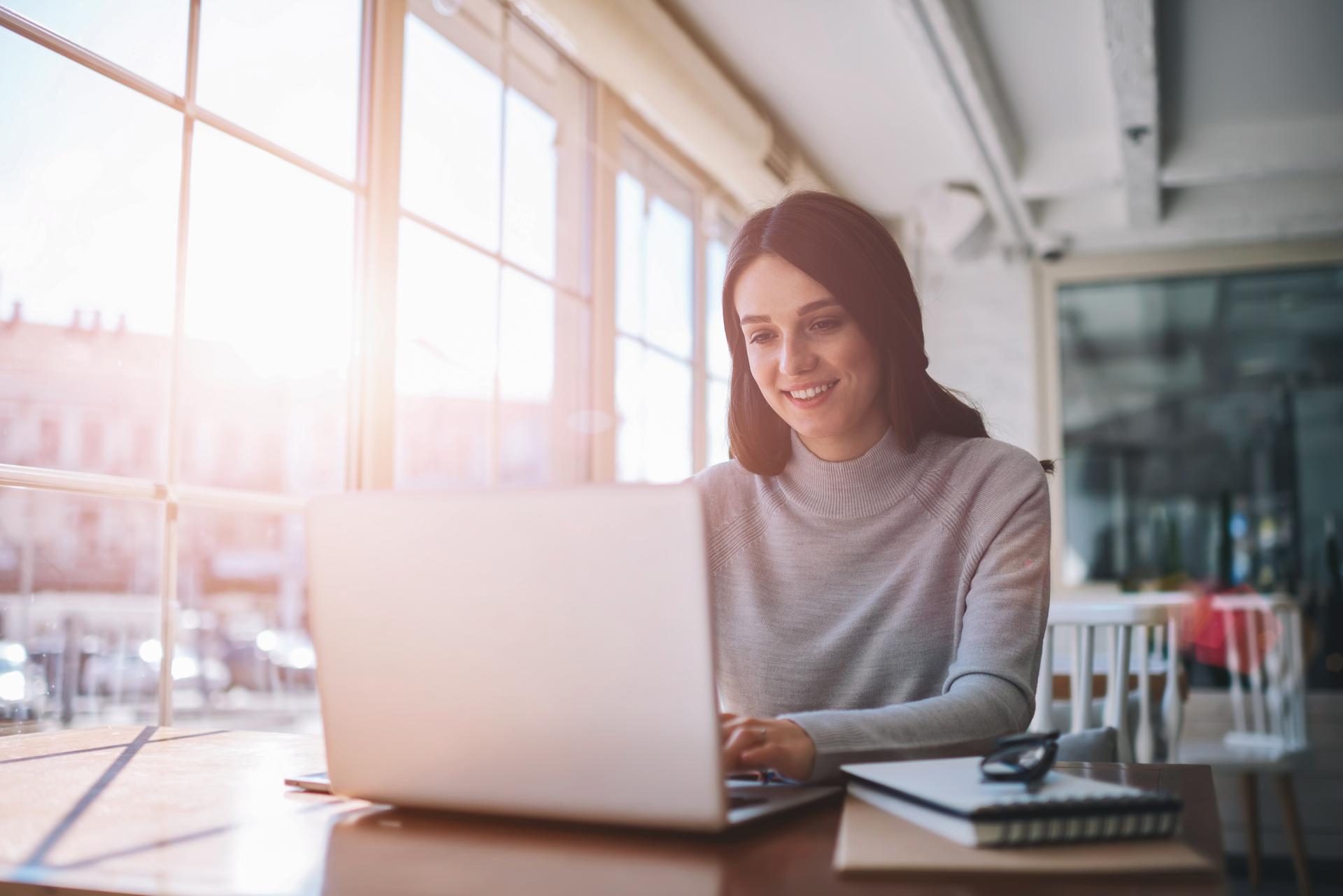 Person working on laptop with sunshine