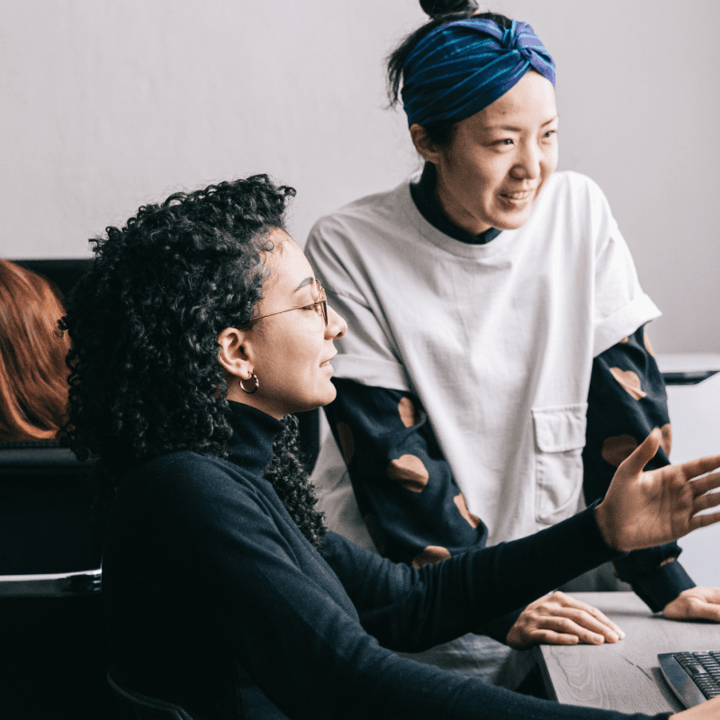 people discussing at computer screen