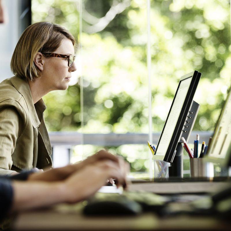 Man and woman working desk computer