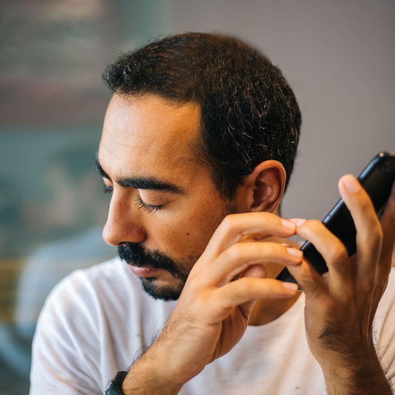 man listening to content on phone