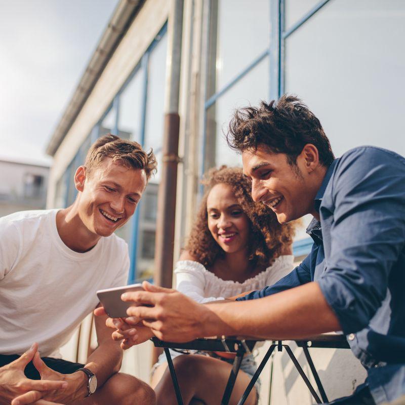 group of people watching phone