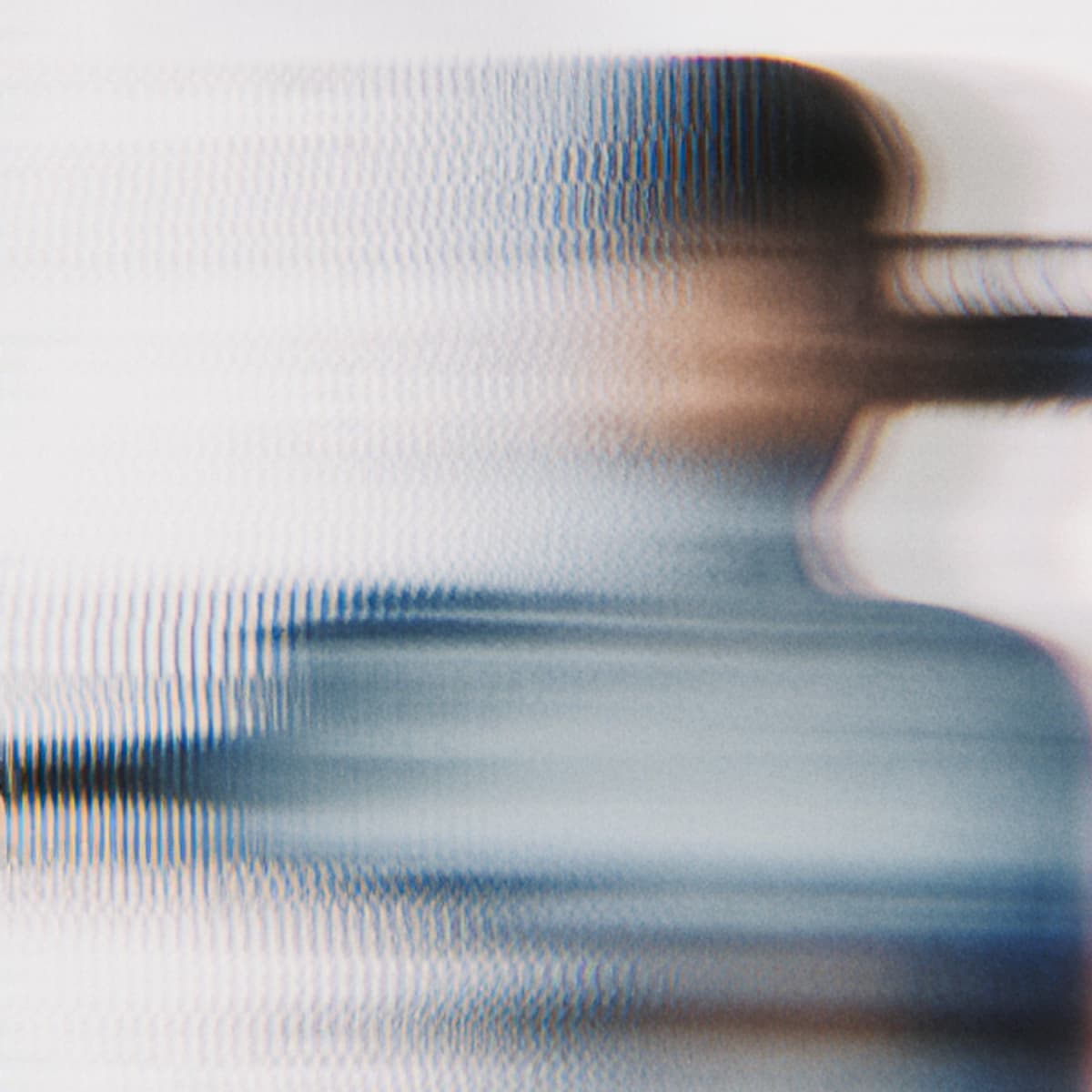 Blurry abstract image with horizontal lines, creating a distorted effect of a person in motion, blending blue and brown hues.