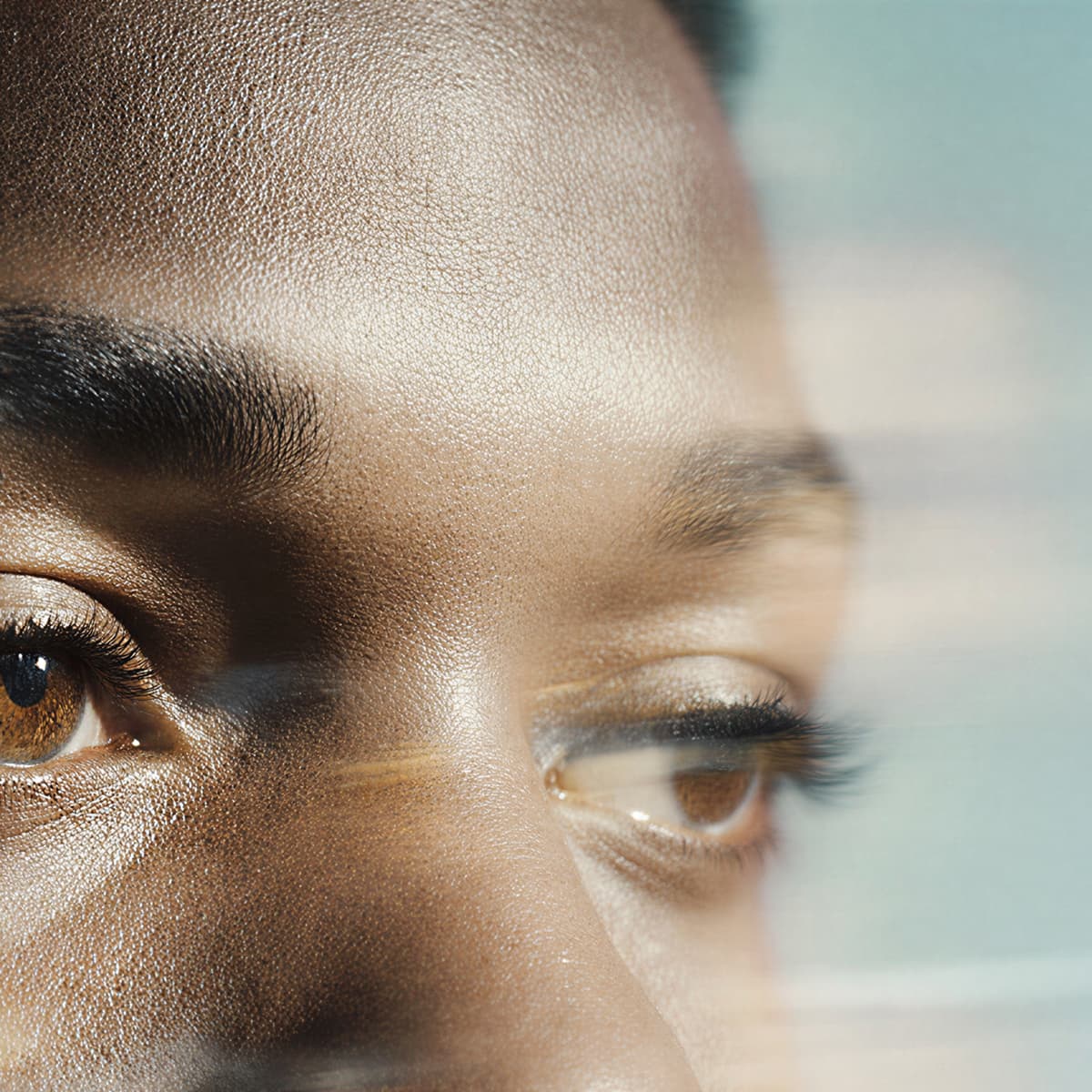 Close-up of a person's face with a soft focus effect. The image highlights the texture of skin and the details around the eyes.